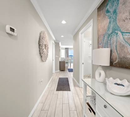 Welcoming entry hallway w/ soft light and coastal touches