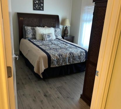 Guest bedroom with new lvt flooring, queen size bed, attached full bathroom!