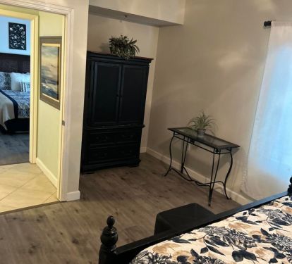 Cabinet houses a flat screen tv and space for clothing. 