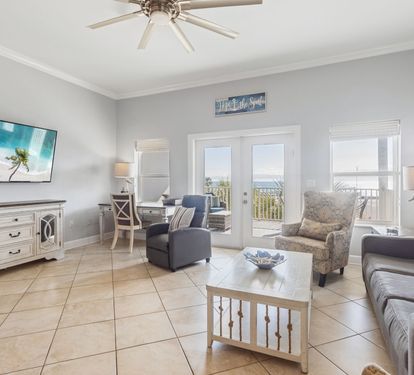 Spacious living area with balcony access and gulf views