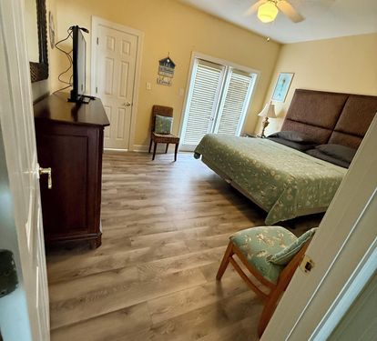Second level by kitchen, King bedroom with private balcony facing the street.