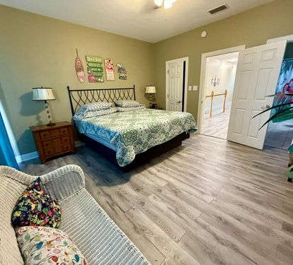 Master king bedroom with private bath and balcony facing the beach.