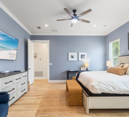 Primary suite with additional seating and large smart TV
