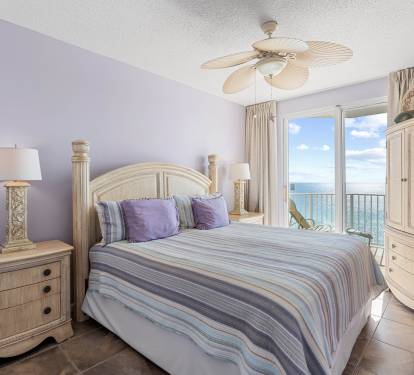 Primary bedroom w/ king bed, soft lighting & a calm coastal feel.