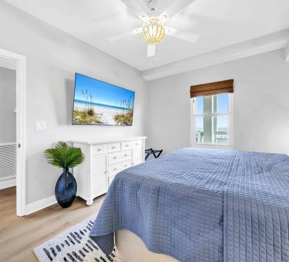Relax in the second king suite featuring a comfortable bed, calming coastal tones, and a 65" smart TV with YouTube TV included or the option to log into your favorite apps.