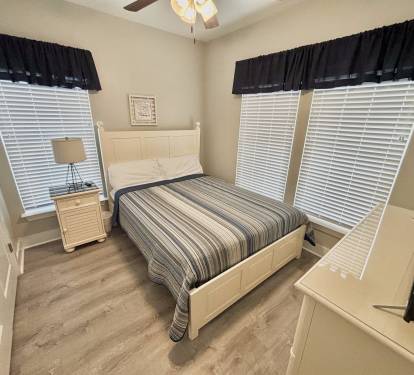 Bedroom #3 with ocean view, queen size bed, and flatscreen TV
