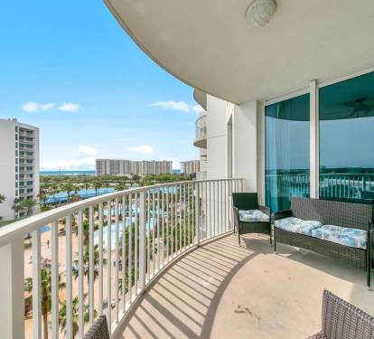 Curved balcony w/ cushioned seating, ideal for morning coffee or unwinding in the sea breeze