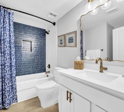 The second king bedroom offers a private en suite bath with additional hallway access, complete with a deep soaking tub/shower combo and comfort-height toilet.