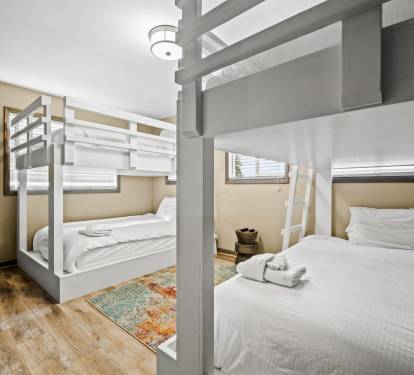 This room features 4 queen beds arranged in 2 bunkbed sets. Perfect for large families, group of friends or guests who want to maximize space while enjoying a good night sleep.