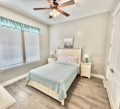 Downstairs bedroom with queen bed and flatscreen TV