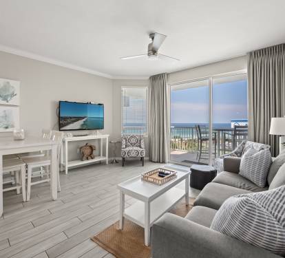 Open living space w/ comfy seating and coastal tones, ideal for relaxing together.