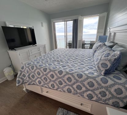 Master Bedroom-King Bed 55" TV with Gulf view and balcony access shiplap wall