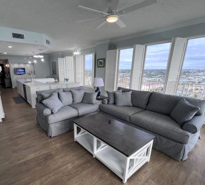 New living room furniture &amp; 65" TV on fireplace overlooking the Gulf