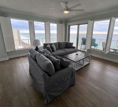 New living room furniture &amp; 65" TV on fireplace overlooking the Gulf
