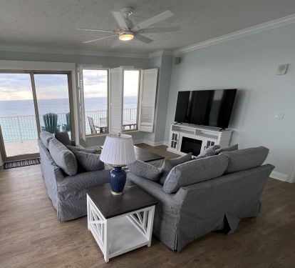 New living room furniture &amp; 65" TV on fireplace overlooking the Gulf