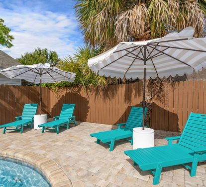 Line up all four turquoise chaise loungers for your crew and
claim your spot in the shade of a white market umbrella. Peak
relaxation mode unlocked. Don't forget your drink!