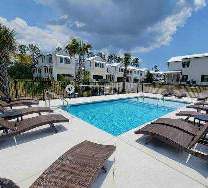 Community pool (non-heated) access for relaxing after a day at the beach 