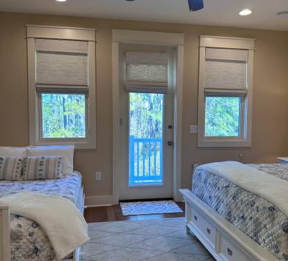 View of the Queen and Full size beds from the en suite bathroom, looking towards the private balcony.