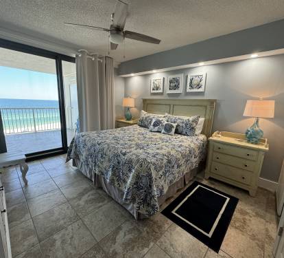 Master Bedroom features a king sized bed with a view of the Gulf of Mexico.