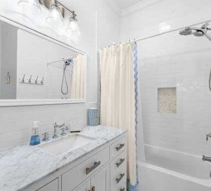 The master bath has been freshly remodeled in bright, coastal tones.