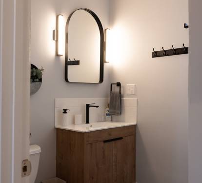 Main Floor Bath. Designer vanity, makeup lights and plenty of storage.