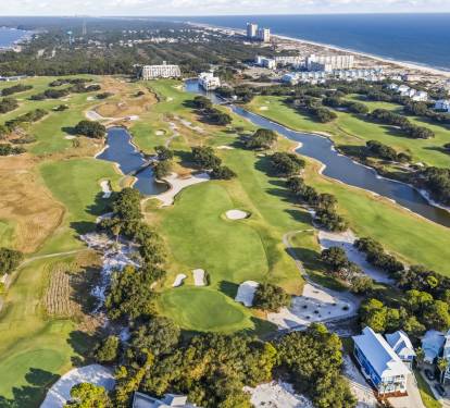 Kiva Dunes Golf Course—an award-winning links-style course set along the Gulf Coast, with rolling fairways, coastal dunes, and water features woven throughout the neighborhood.