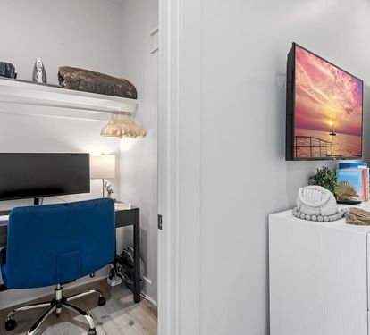 Dedicated Workspace - Tucked off the first-floor king suite, this private workspace features a small window, door, desk, comfortable chair, large monitor, docking station, keyboard, and a mouse—ideal for remote work while enjoying your beach getaway.