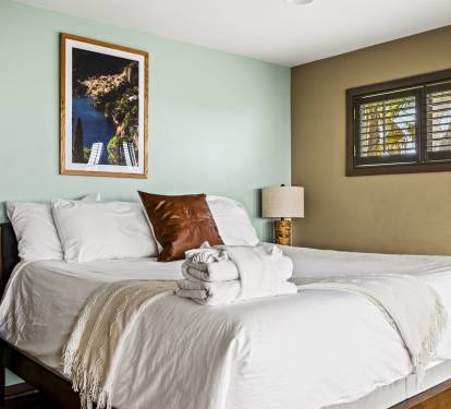 Tropical chic Master bedroom equipped with a comfortable king-size bed and access to a tranquil private veranda.