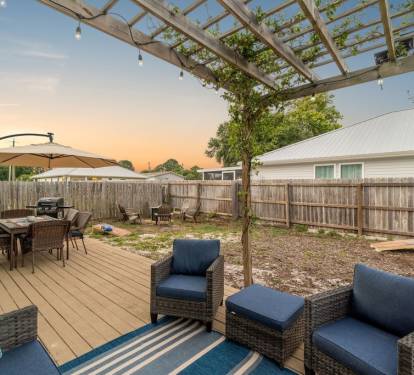 Enjoy the outdoor seating on the back deck under the pergola.