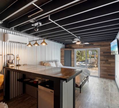 Microwave, refrigerator and sink complete the kitchenette