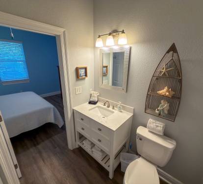 Bright modern finishes and direct bedroom access create a private bath designed for ease and everyday convenience.
