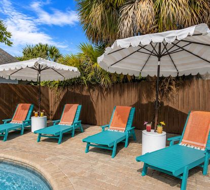 Line up all four turquoise chaise loungers for your crew and
claim your spot in the shade of a white market umbrella. Peak
relaxation mode unlocked. Don't forget your drink!