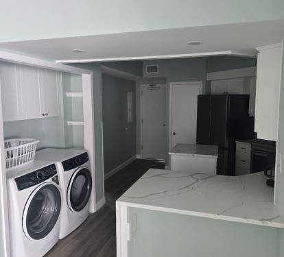 Brand New Everything!  Kitchen view with the updated Laundry station.