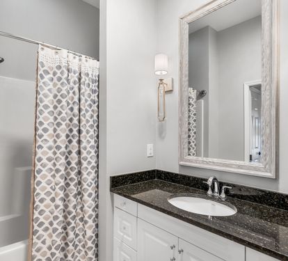 Ensuite bathroom with granite vanity and shower/tub combination