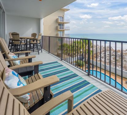 ?? "Luxury Meets the Coast. Relax on the oversized balcony with high-end furnishings, offering stunning views of the beach and pool at After Dune Delight." ?????