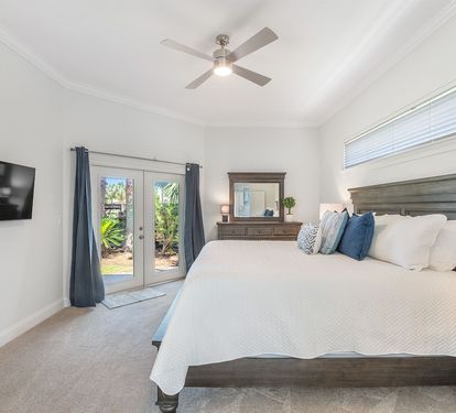 Primary bedroom with king bed and access to the back porch
