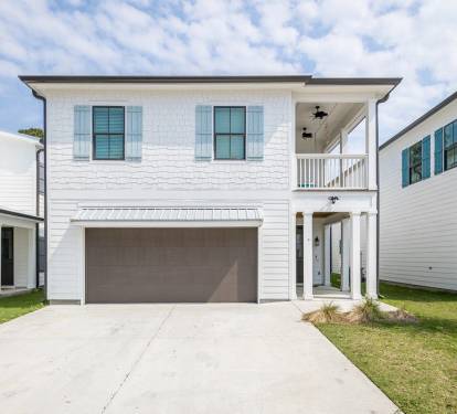 Beautiful White Exterior with Blue Window Panels Exude Both Coastal and Modern Vibes