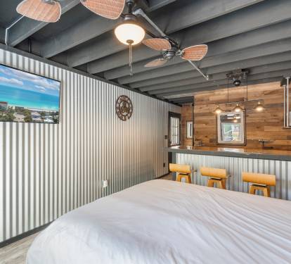 Downstairs casita features a queen bed, kitchenette with a steampunk vibe