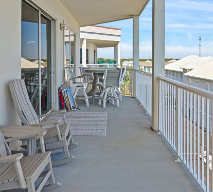Balcony seating overlooking the sugar-white sand