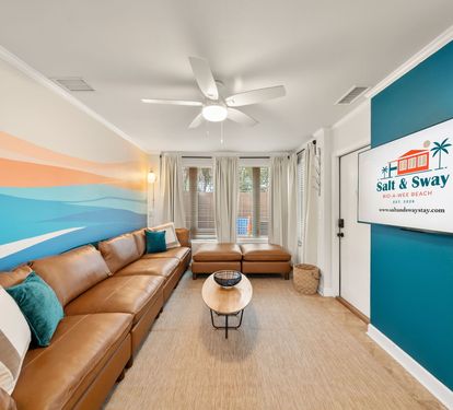 Gather the whole crew in the open living room under the
hand-painted surf-wave mural. The oversized sectional fits everyone for movie nights, game streaming, or just unwinding after the
beach.