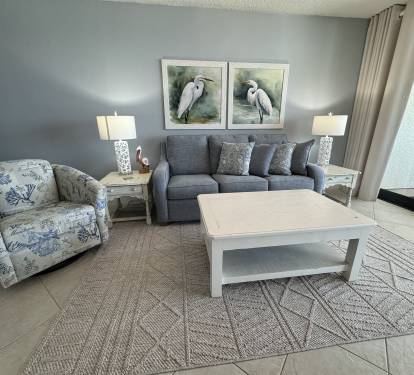 Living Room featuring all new sofa, tables, chairs, lamps and art.