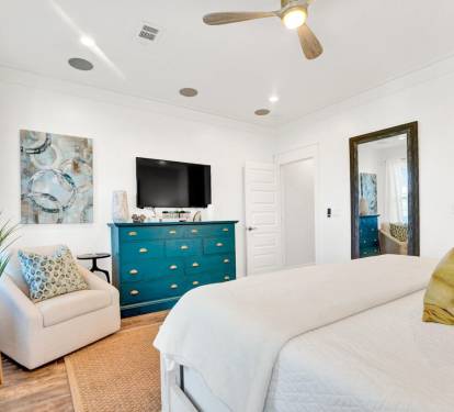 Primary retreat with ceiling fan, private balcony, ceiling fan and 55" TV