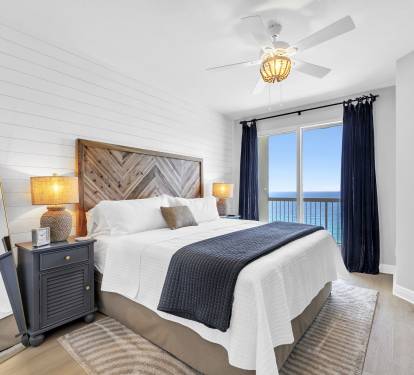 Wake up to breathtaking Gulf views in this serene primary bedroom with en suite, featuring a plush king bed, cozy linens, and direct balcony access—perfect for relaxing after a day at the beach.
