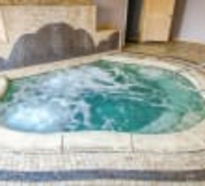 Indoor hot tub, located poolside!