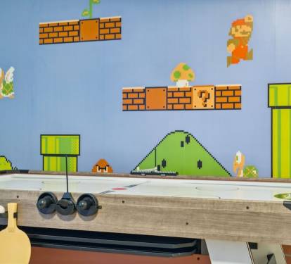 The Game Room is located on the second level  and includes Teenage Mutant Ninja Turtles arcade game, Marvel pinball machine, air hockey/ping pong table, mini fridge, and game stick with countless retro games,  with access to the front balcony.