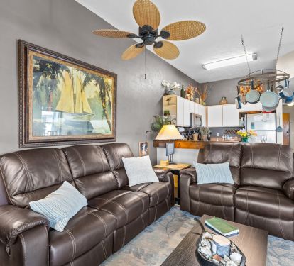 Another view of the living room with reclining sofa and love seat. 