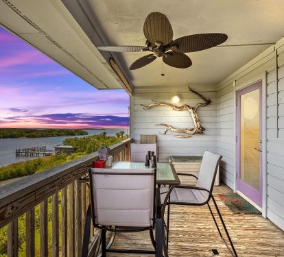 Cedar Key Tranquility's Balcony with five high top chairs and fan.