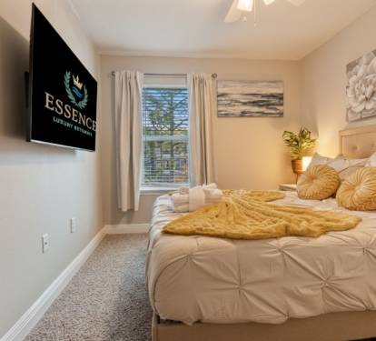 Cozy, beautifully styled bedroom with a plush bed, soft linens, and calming d&eacute;cor. Enjoy natural light, a wall-mounted TV, and a peaceful atmosphere perfect for relaxing and recharging after a fun day out.