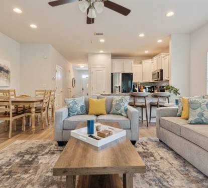 Bright, modern open-concept home with a cozy living area, stylish furnishings, and fully equipped kitchen. Enjoy comfortable seating, dining space, and natural light perfect for relaxing, working remotely, or hosting a memorable stay.