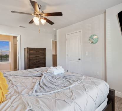 Relax in this serene bedroom featuring a plush bed, stylish wood headboard, smart TV, and soft natural light. Thoughtfully designed for comfort and rest, it&rsquo;s the perfect retreat after a day of adventure or work.